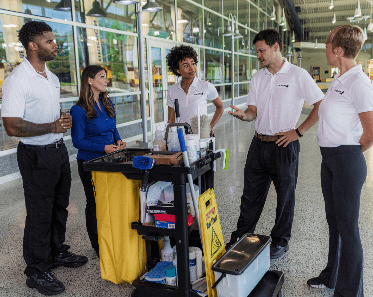 Members of Aramark Facilities Management standing around at a building. 